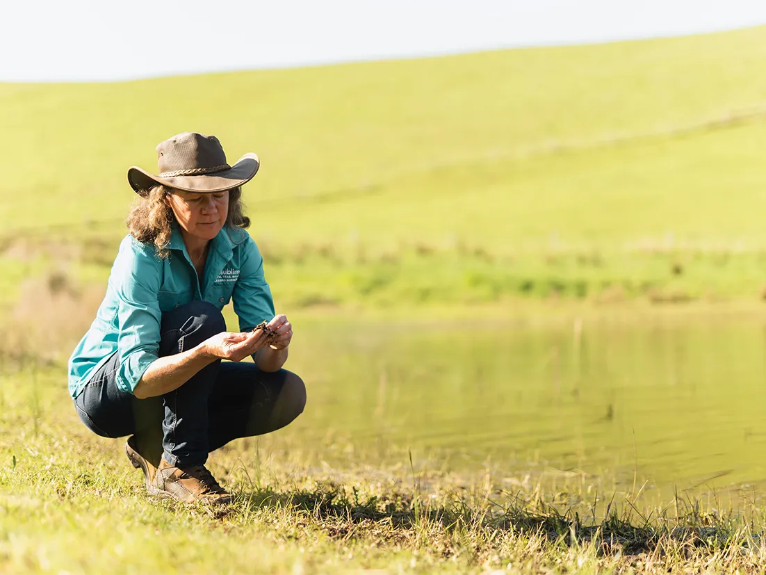 Children smiling while filling gallons with water