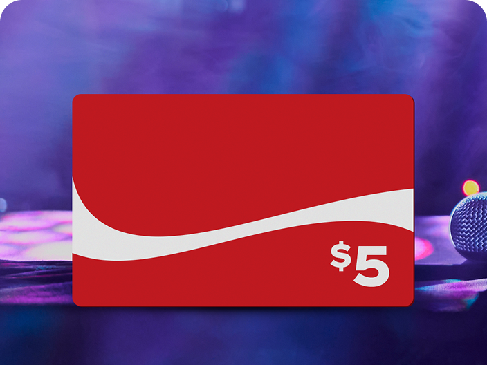 A red $5 prepaid Coca-Cola gift card, available as a prize in the Festive Moments pool, shown against a concert background.