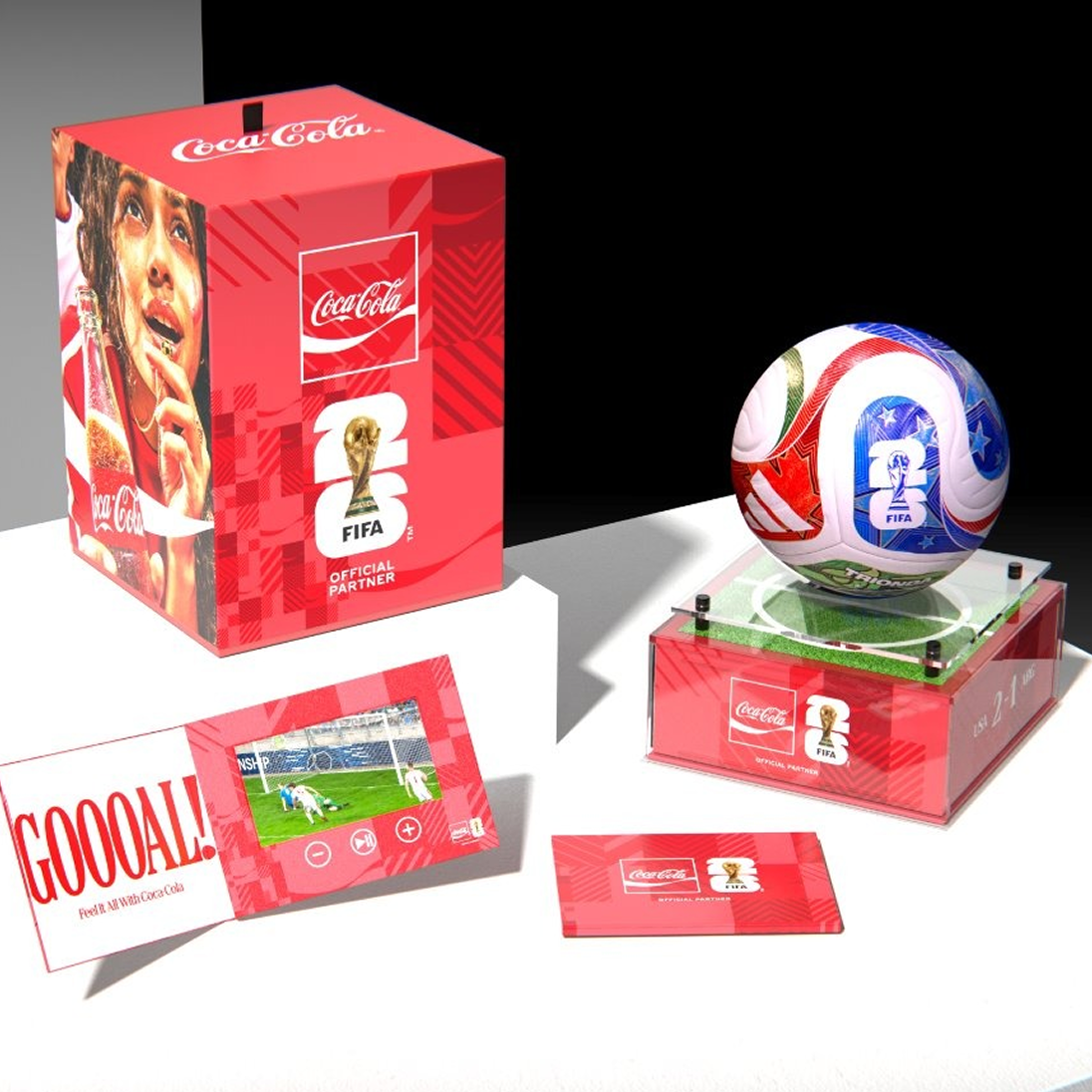 Coca-Cola FIFA match ball prize bundle with red gift box, video card booklet and display case holding official match ball on stand.