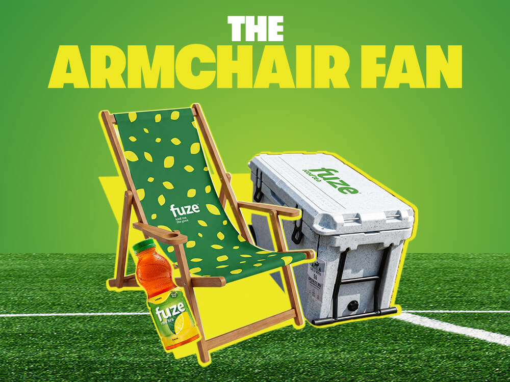 FUZE iced tea Armchair Fan graphic with green deck chair, branded cooler and bottle on soccer pitch under yellow headline.