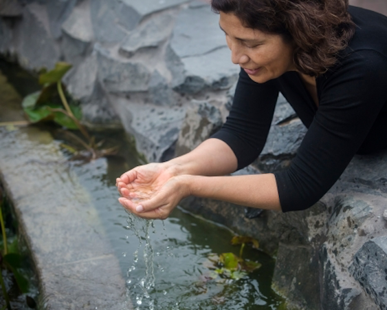  A woman cupping clean water with her hands