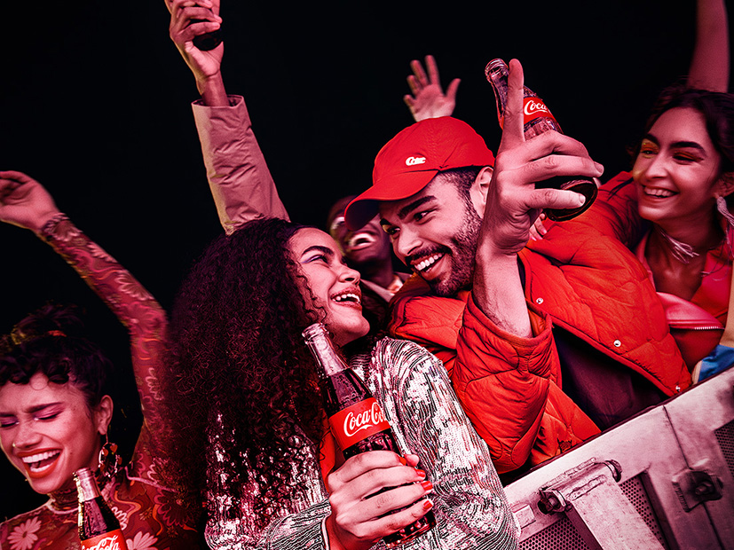 Group of people enjoying Coca-Cola at an event.