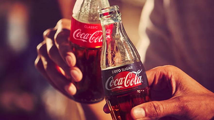 Photo of two glass bottles, one being Coke Zero, the other one Coke Original