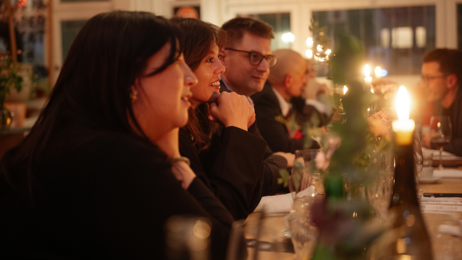 Guests sitting at the table with candles