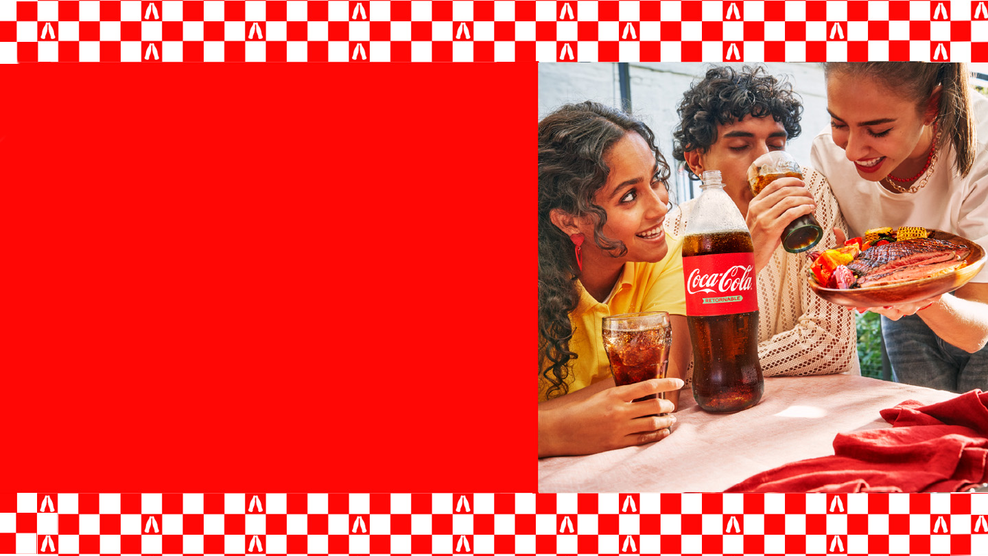 Tres amigos disfrutan de una comida al aire libre con Coca-Cola. Una botella de Coca-Cola retornable está sobre la mesa. La imagen tiene un borde superior e inferior con un patrón de cuadros rojos y blancos, y un gran espacio rojo liso a la izquierda.