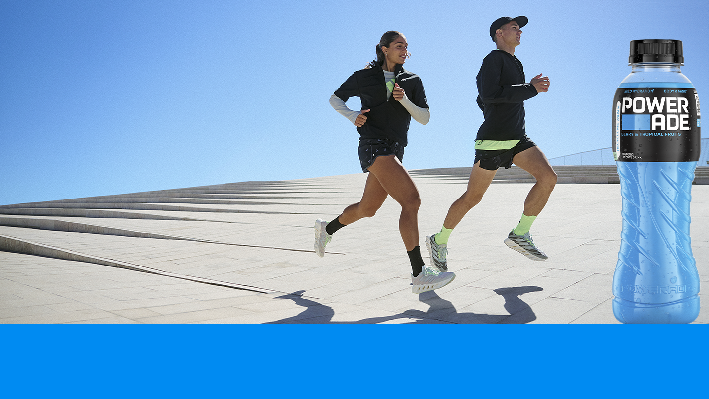 people running in adidas clothing and a bottle of powerade