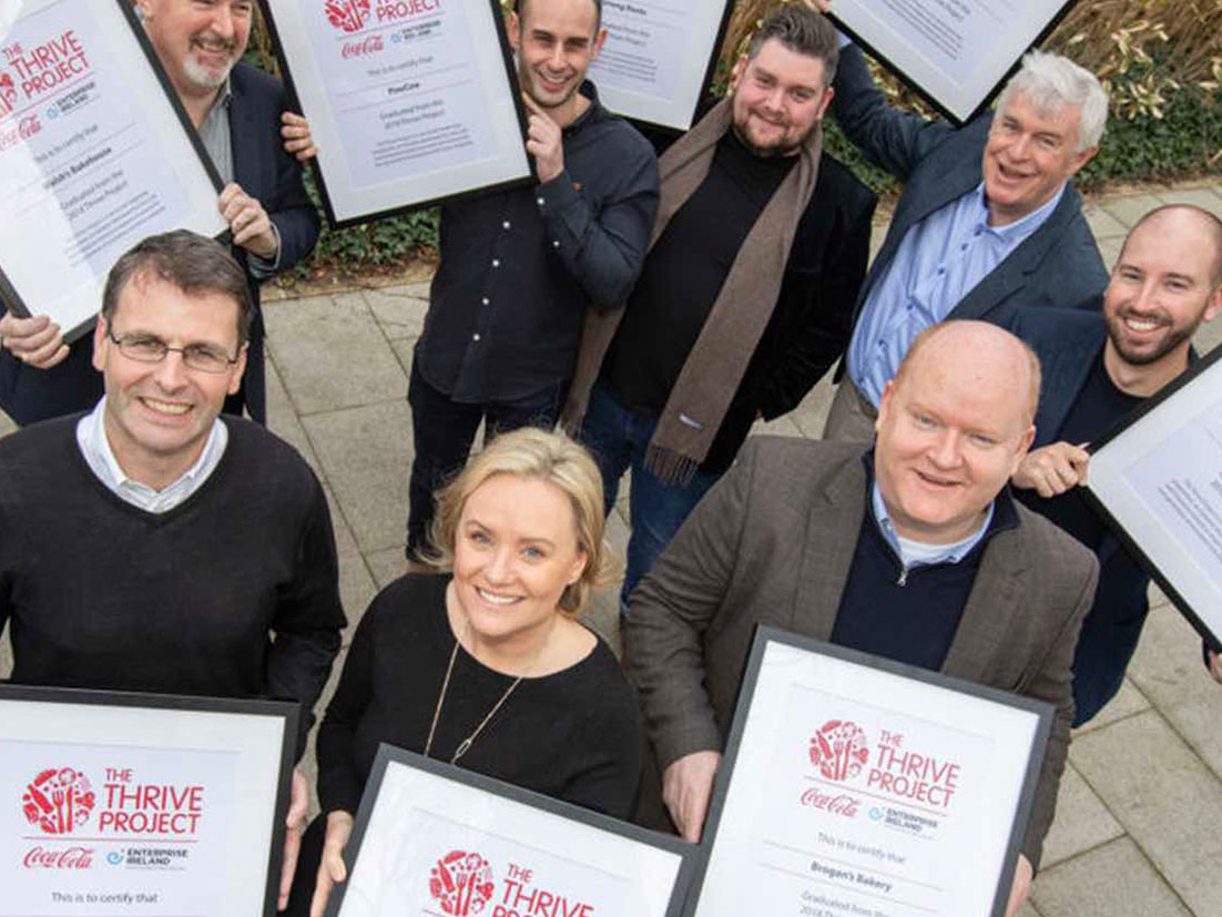 Group of people in suits showing The Thrive Project certifications