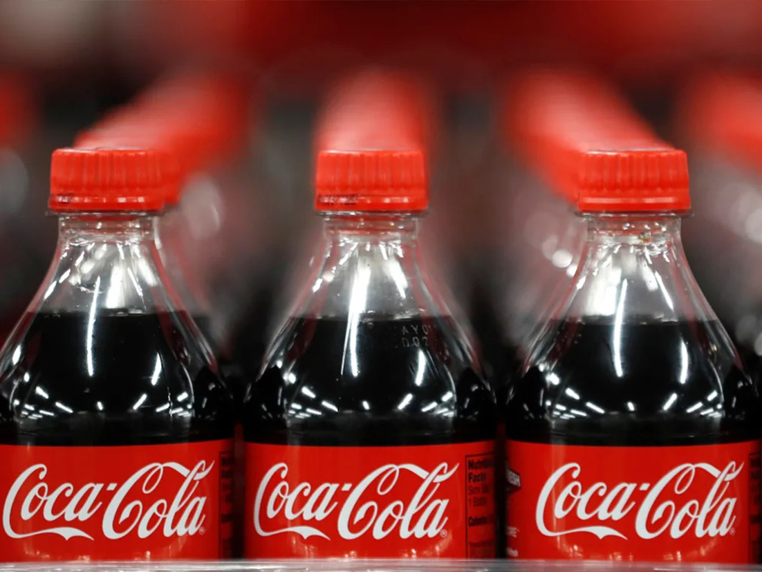 Detail of multiple bottles of Coca-Cola lined up