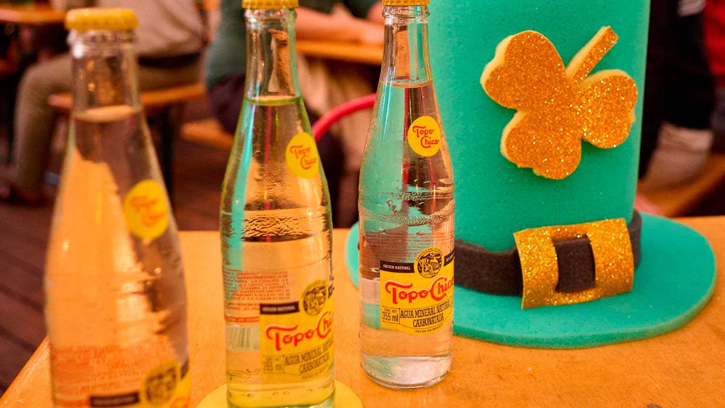 Hombre sentado en Dodo Café junto a una botella Topo Chico