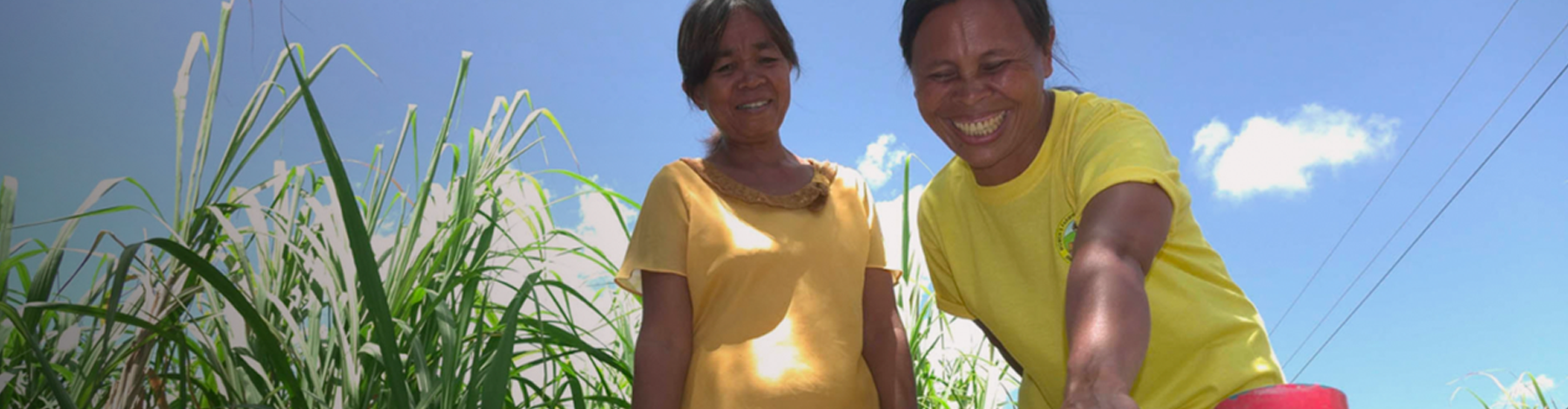 Two women with yellow t-shirts smiling