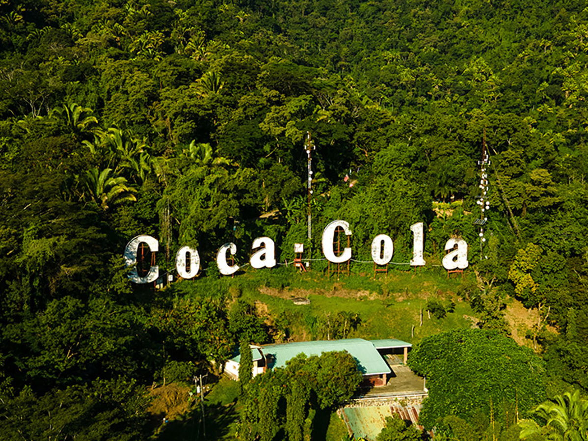 Aerial view of a Coca-Cola sign in a forest