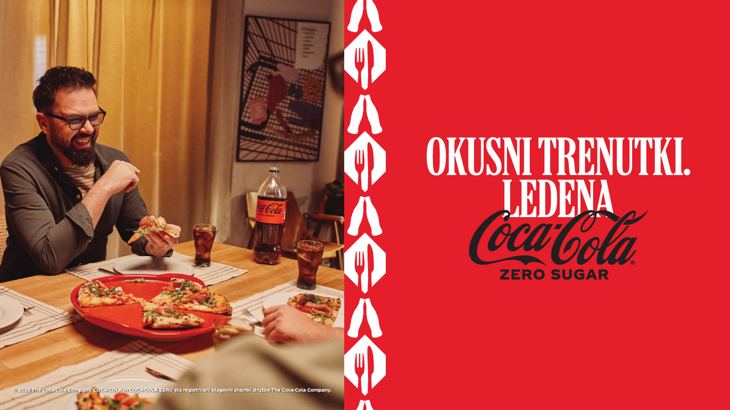 Petar Grašo sedi za mizo ob pici in Coca-Coli Zero Sugar.