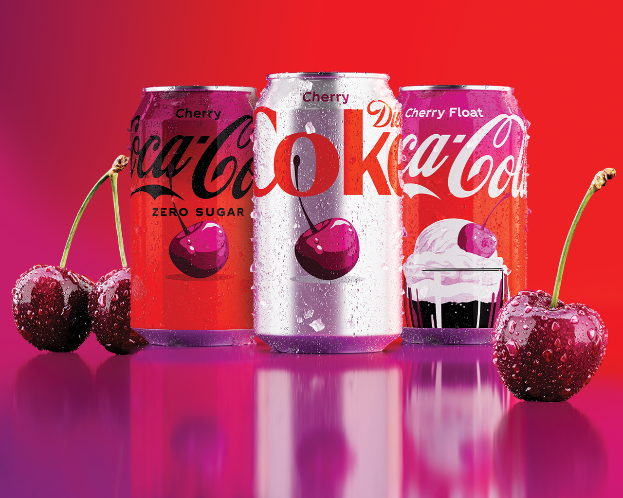 Three Coca-Cola cans — Cherry Coca-Cola Zero Sugar, Diet Cherry Coke, and Cherry Float Coca-Cola — stand against a red-to-magenta gradient background, flanked by glistening fresh cherries with stems.