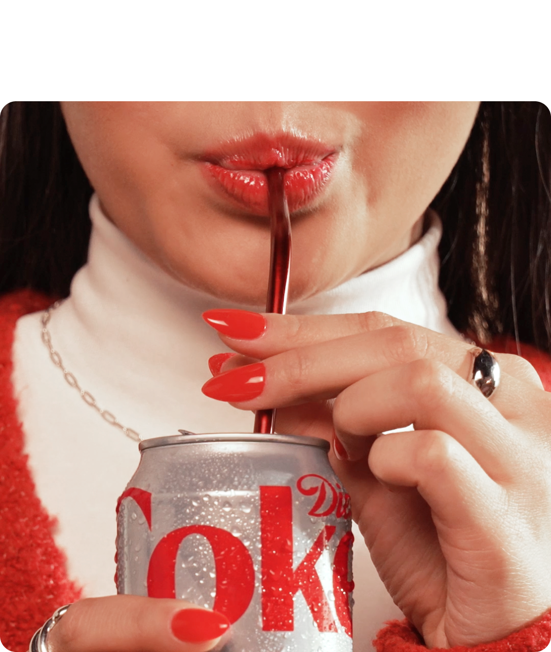 Women drinking diet coke using a straw