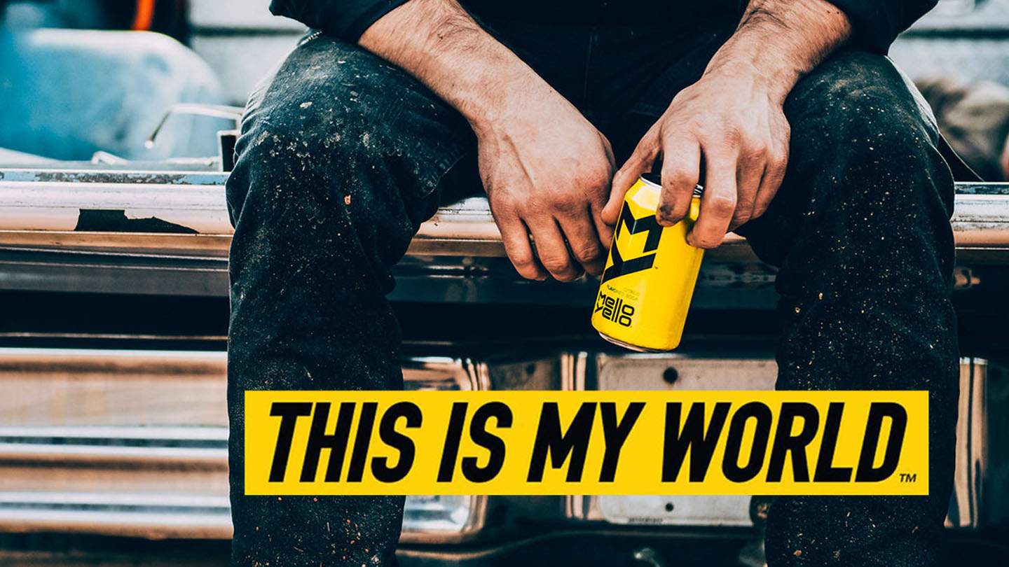 Closeup picture of a person sitting down holding a Mello Yello can with the words "This is my world" below 