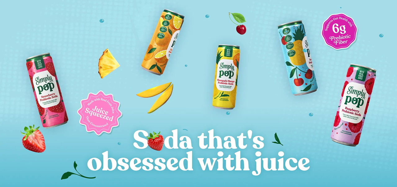 Five Simply Pop prebiotic soda cans in Strawberry, Orange, Pineapple Mango, Cherry Pomegranate, and Raspberry flavors, surrounded by fresh strawberries, pineapple, mango, and cherries on a light blue background. Badges read "Juice Squeezed, Not Concentrated" and "Supports Gut Health with 6g Prebiotic Fiber," with tagline text "Soda that's obsessed with juice."