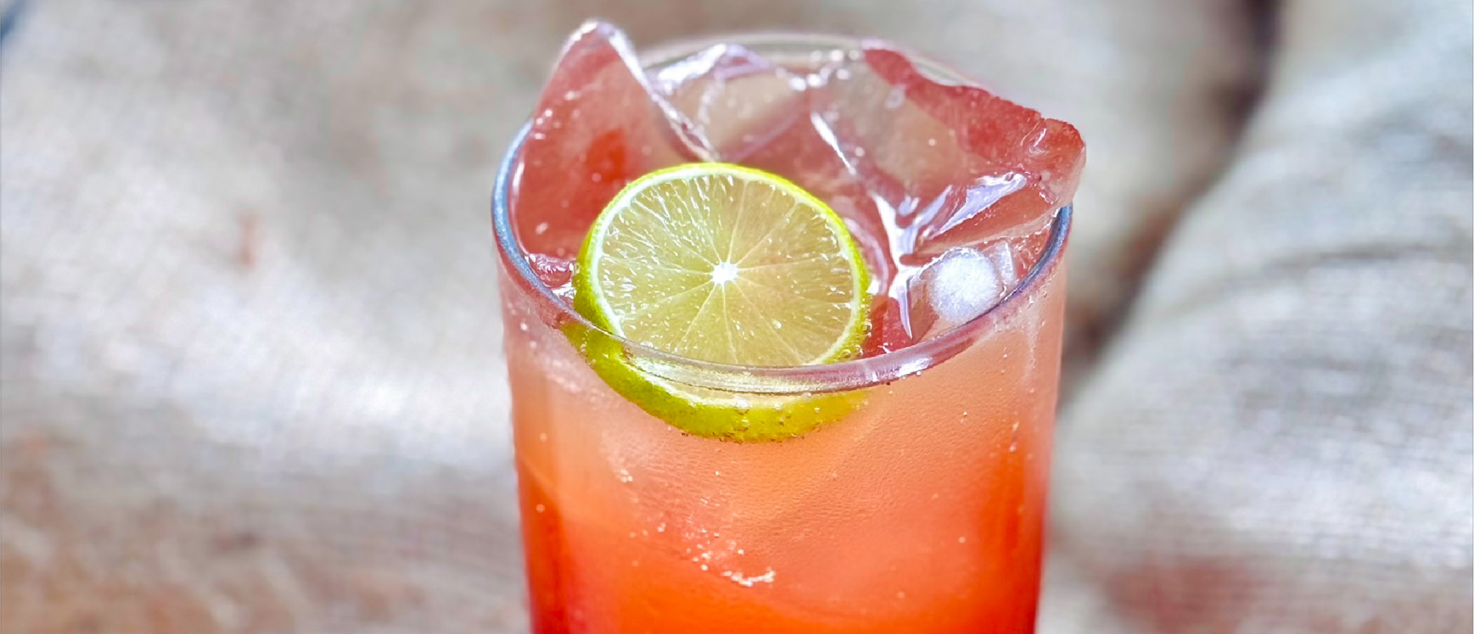 Cold brew fizz in a glass with ice and lemon wedge