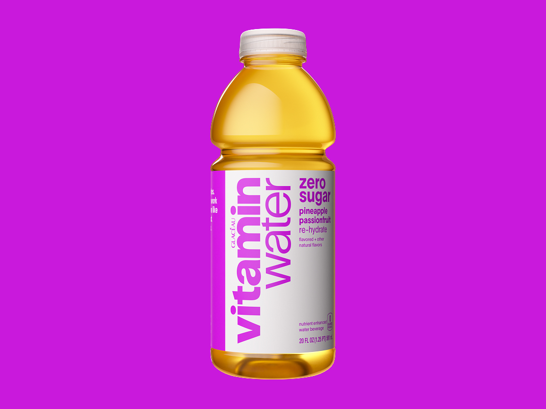 a bottle of vitaminwater zero sugar pineapple passionfruit on a magenta background