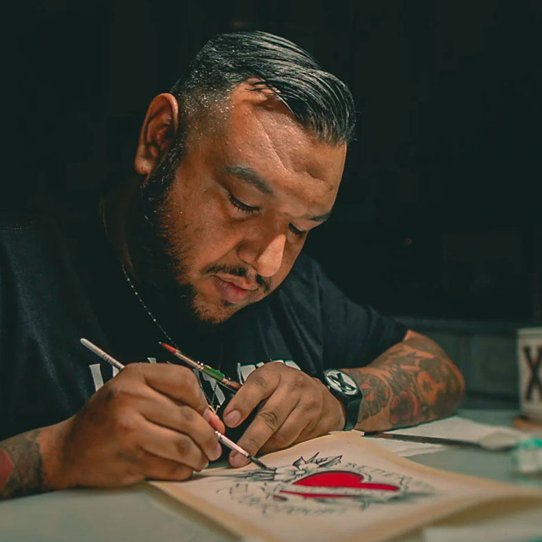 Gustavo Jaimes holding a tattoo machine