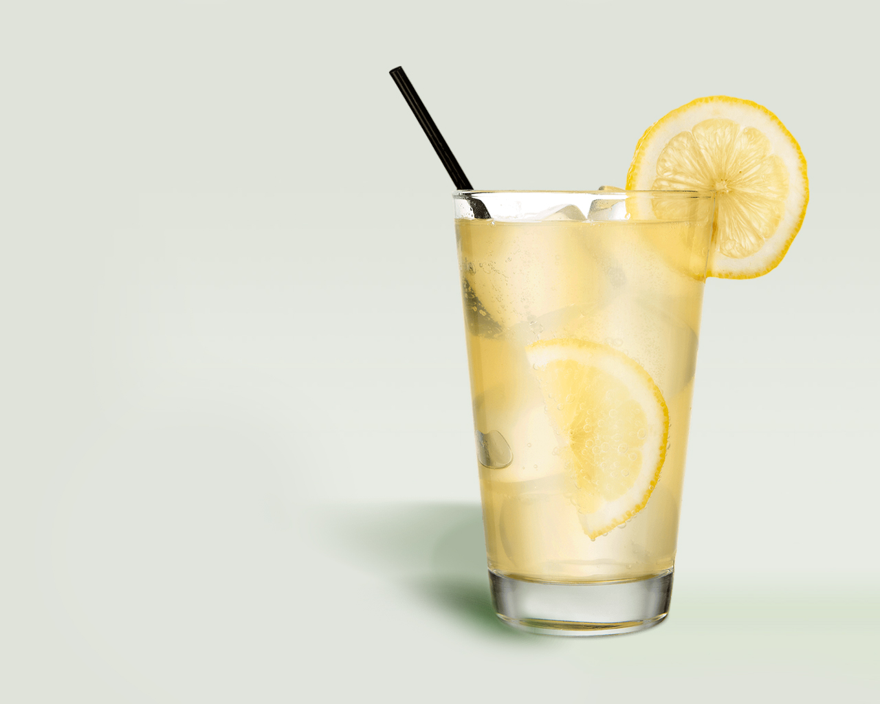 Glass of juice with lemon and ice