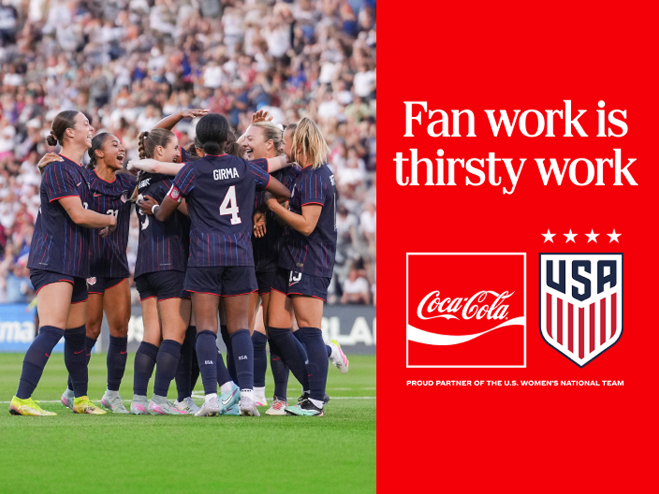 USWNT players celebrate in a huddle on the field next to a red Coca-Cola banner reading "Fan work is thirsty work."