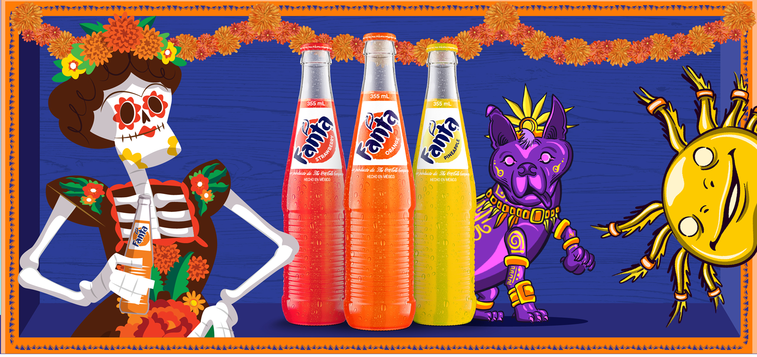 A stylized female skeleton figure with a floral headdress and painted marigold face holds a bottle of Fanta Strawberry beside three Fanta bottles (Strawberry, Orange, and Pineapple, each 355 mL, Hecho en México) and a purple, gold-adorned Xoloitzcuintle dog figure. A marigold garland runs across the top of the deep blue scene, with a stylized sun illustration to the right.