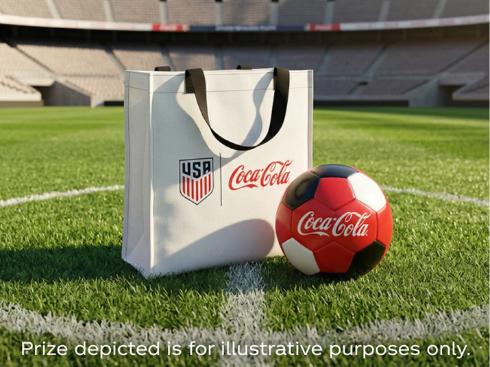 Coca-Cola and U.S. Soccer tote bag with red soccer ball sitting on stadium field promoting Matchday prize giveaway.