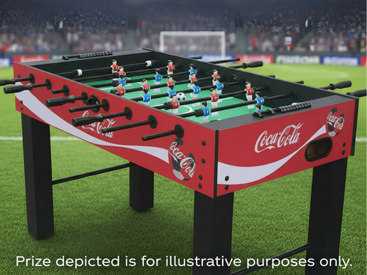 Red Coca-Cola branded foosball table on soccer pitch used as Matchday sweepstakes prize visual.