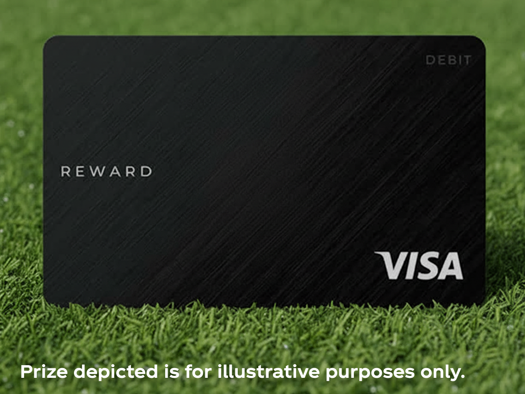 Black prepaid reward card resting on soccer field grass representing Match Day Getaway sweepstakes spending money prize