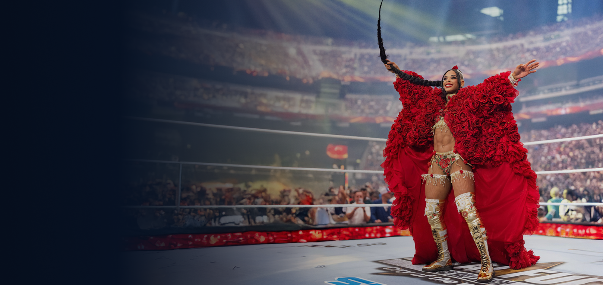 Minute Maid x WWE Survivor Series banner featuring performer in red rose robe making dramatic ring entrance before stadium crowd.