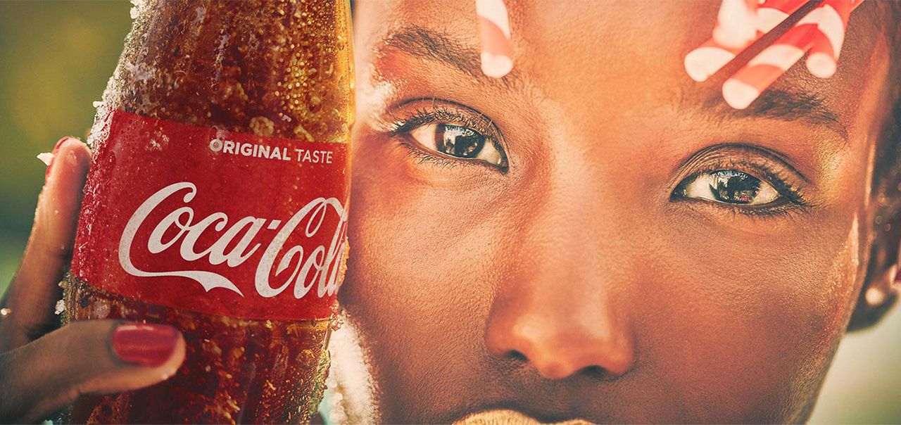 Women holding a Coca-Cola Original bottle